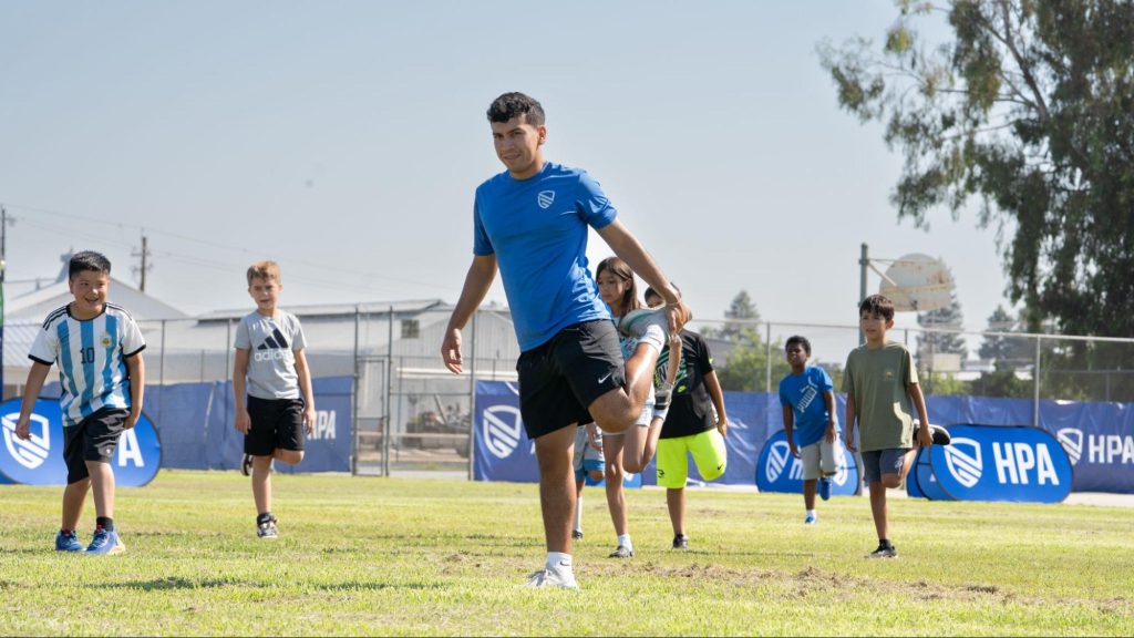 elop coach demonstrating stretches for school aged kids 